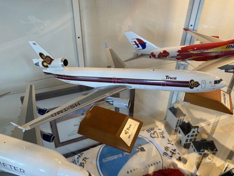 a group of model airplanes in a glass case
