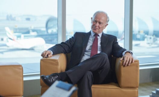 a man in a suit sitting on a couch