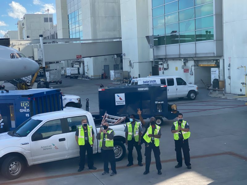a group of people in safety vests standing in front of a truck