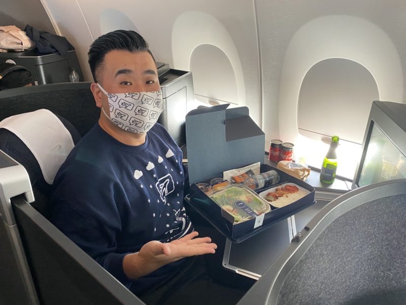 a man wearing a mask and sitting in an airplane