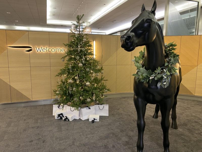 a statue of a horse with a wreath around it