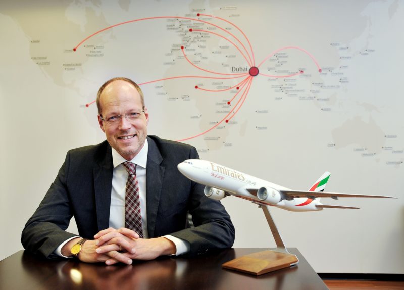 a man sitting at a desk with a model airplane