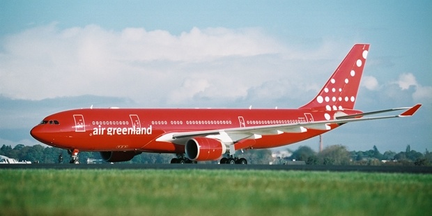 a red airplane on the runway