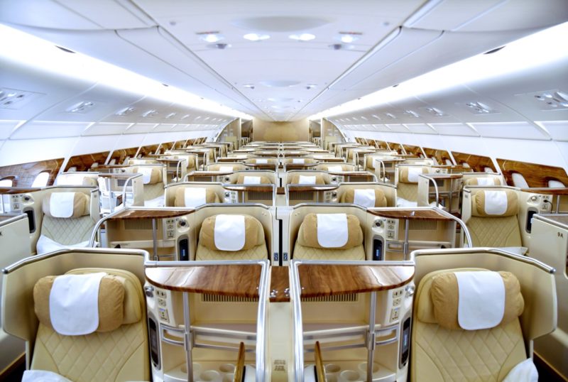 inside a plane with seats and a wooden seat