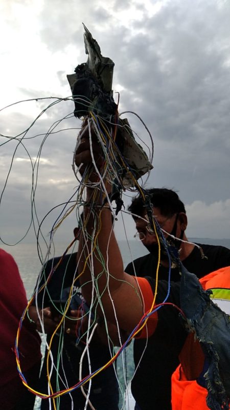 a group of people holding wires