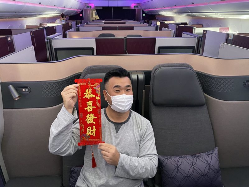 a man wearing a face mask holding a red scroll