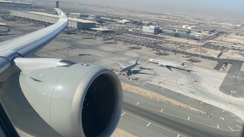 an airplane wing and engine on runway