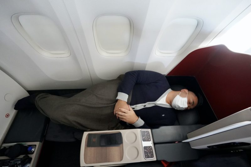 a man sleeping on a plane