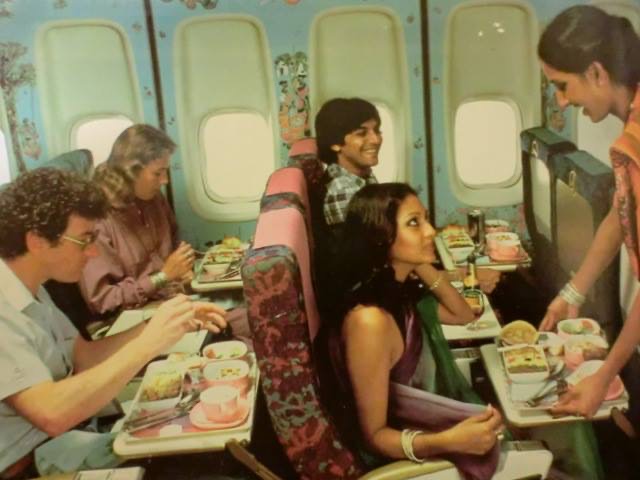 a group of people sitting in a plane eating
