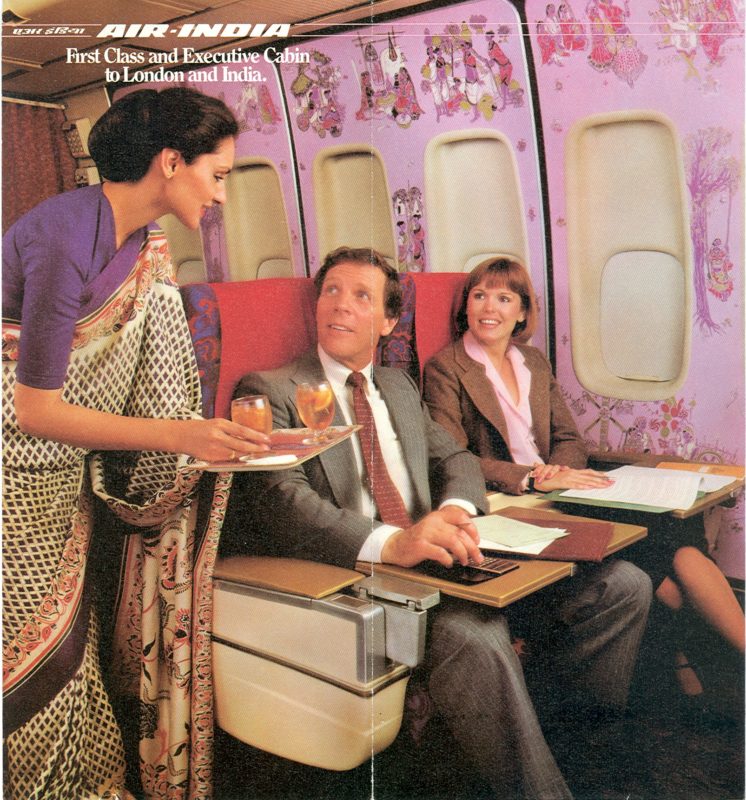 a woman serving drinks to a man in an airplane