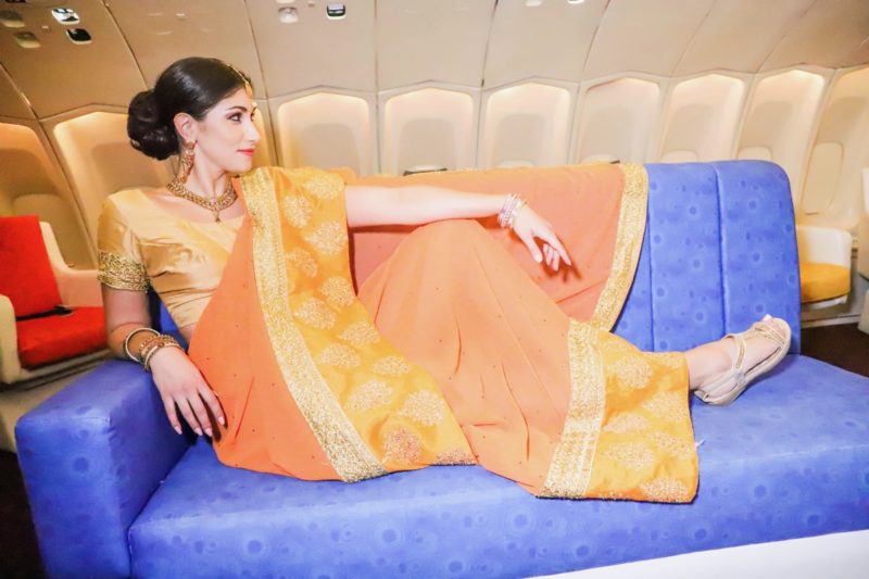 a woman in a sari on a blue couch