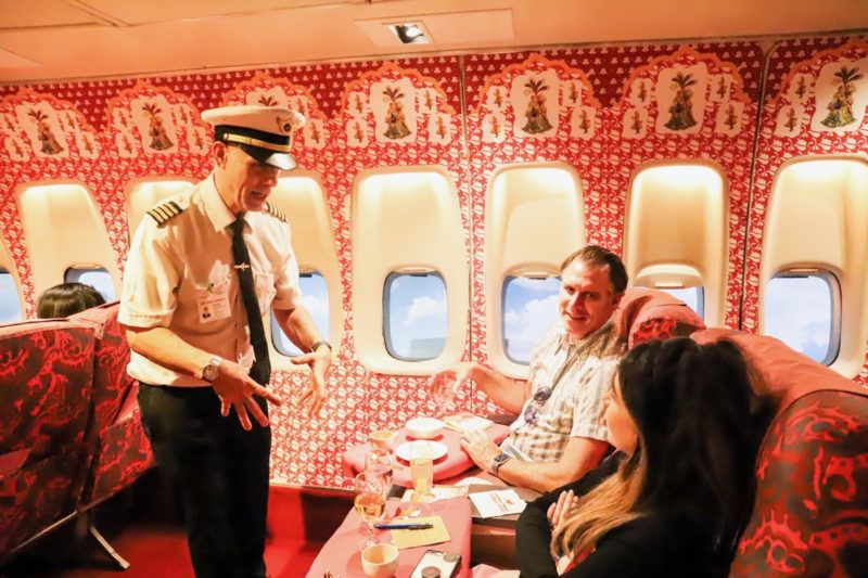 a man in uniform talking to a group of people