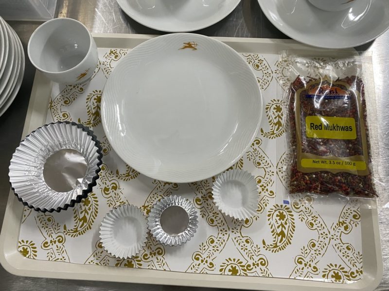a tray with a plate and cups