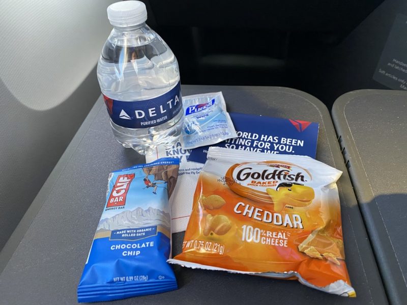 a bottle of water and snacks on a table