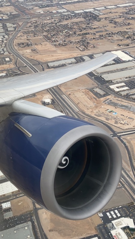 an airplane wing with a blue and silver engine
