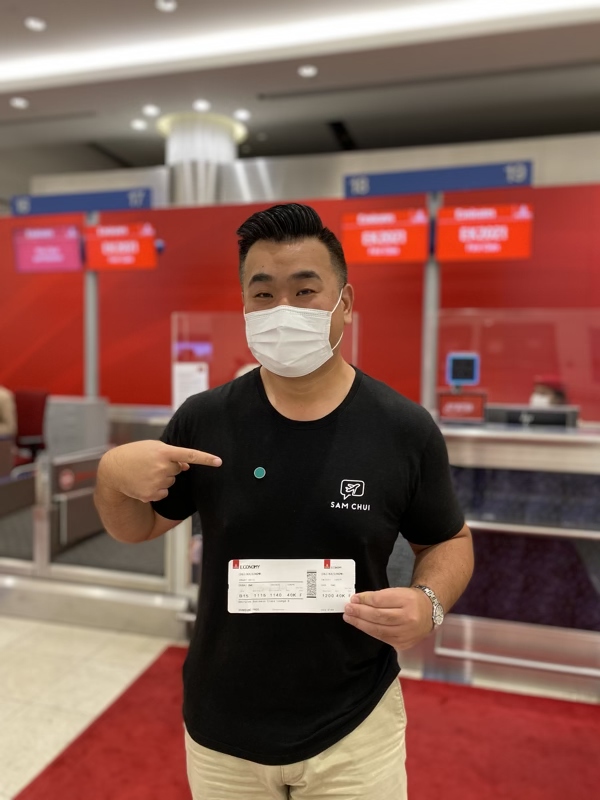 a man wearing a mask pointing at a ticket