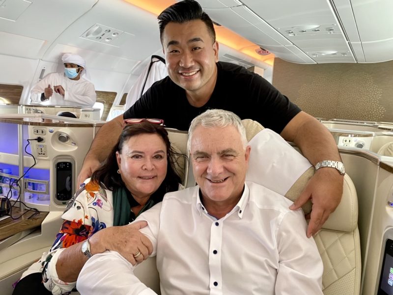 a group of people sitting on a chair in an airplane