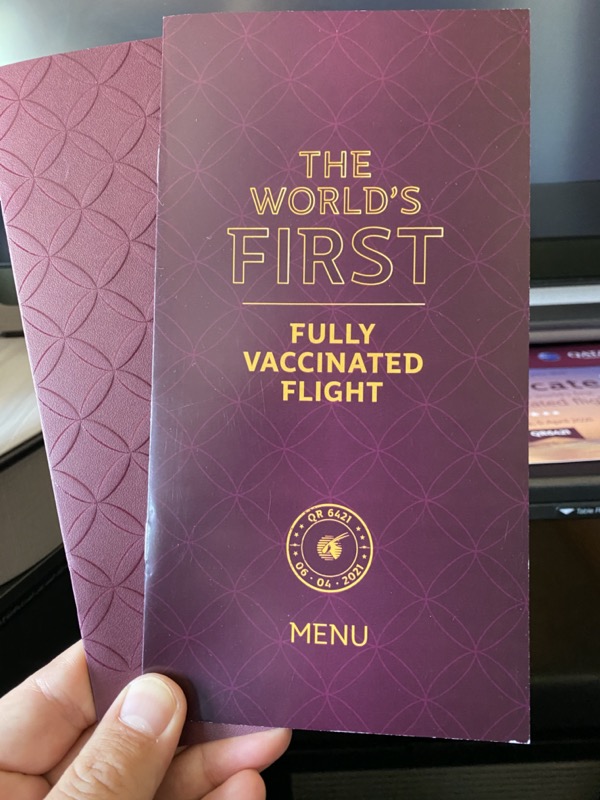 a hand holding a purple menu