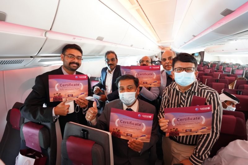 a group of men holding signs on an airplane