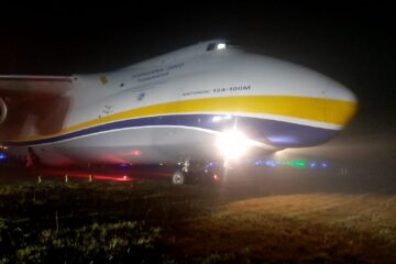 a large airplane on a field at night
