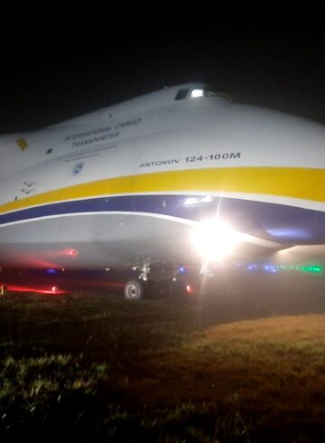 a large airplane on a field at night