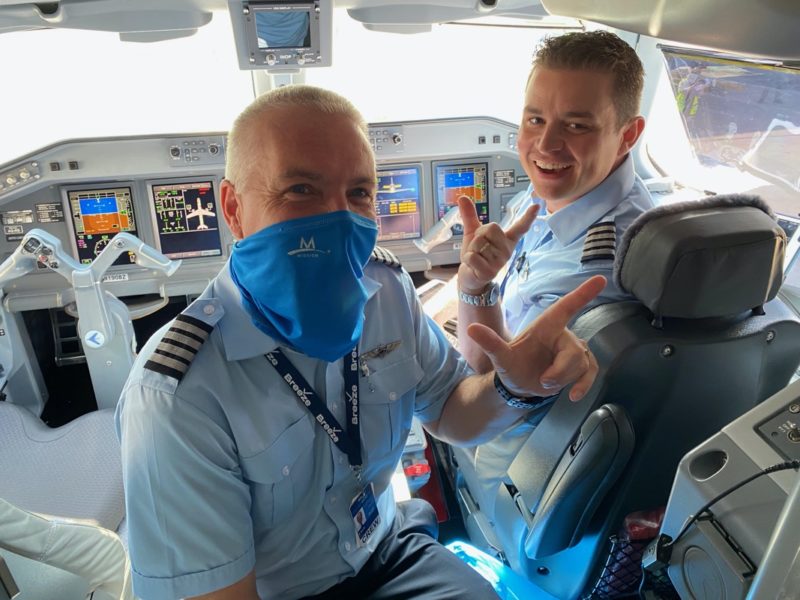 two men in uniform in a cockpit