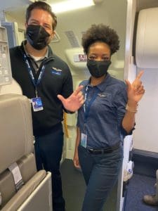 a man and woman wearing face masks