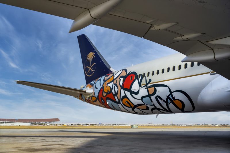 the tail of an airplane with graffiti on it