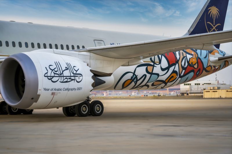 a white airplane with graffiti on the side