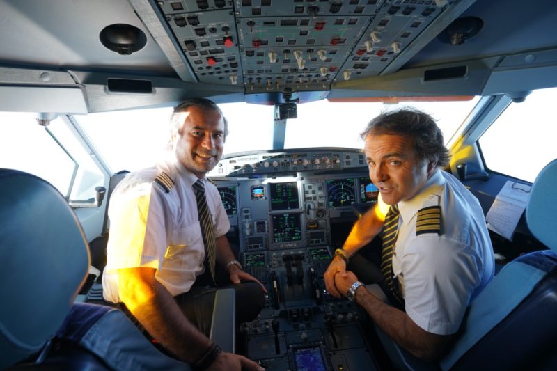 a few pilots in the cockpit of an airplane