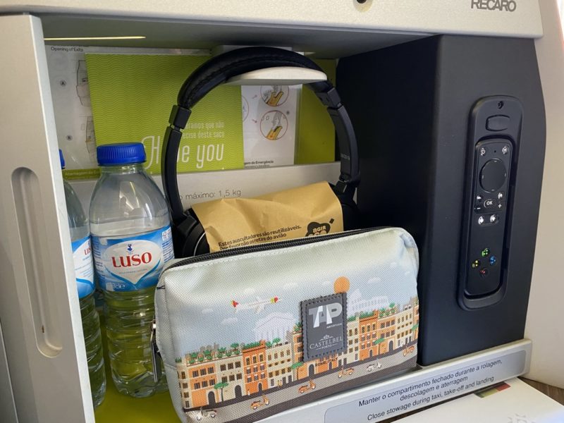 a phone and headphones on a shelf