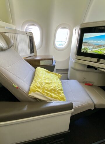 a seat in an airplane with a television