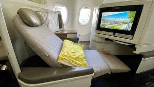 a seat in an airplane with a television