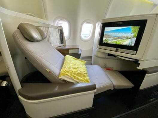 a seat in an airplane with a television