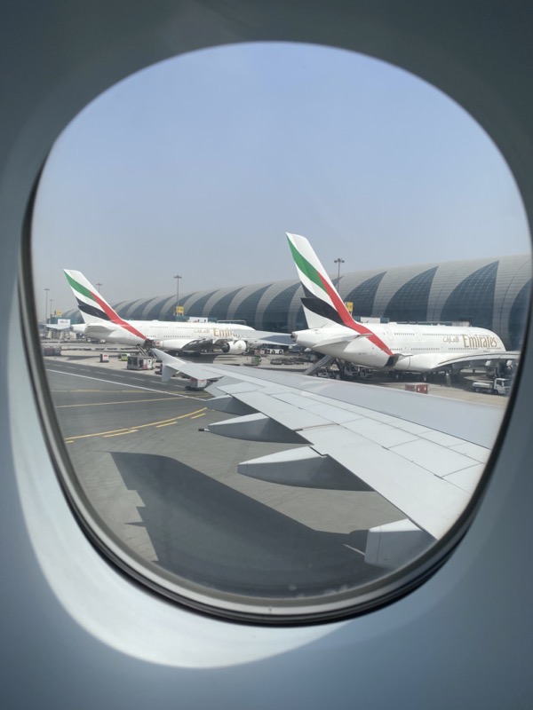 a plane window with a view of airplanes