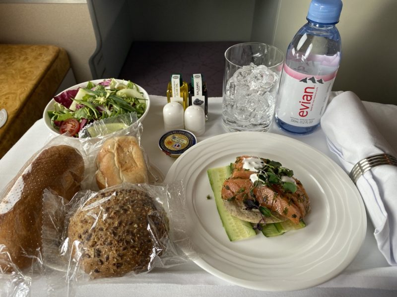 a plate of food and a bottle of water on a table