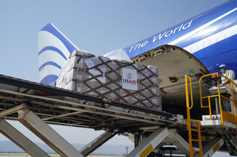 a plane loading cargo into the plane