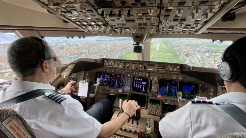 two men in a cockpit of an airplane