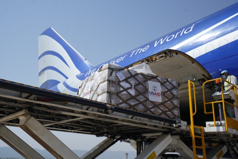 a plane loading cargo with boxes