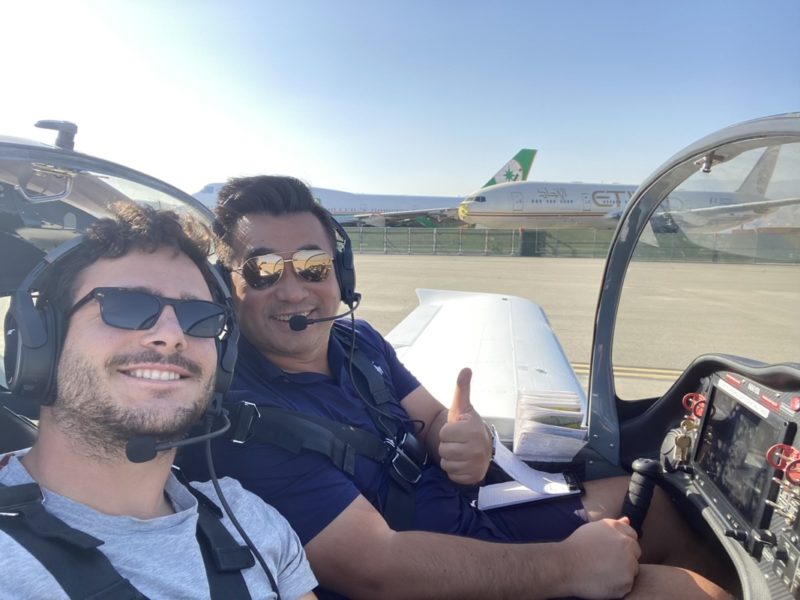 two men sitting in a plane