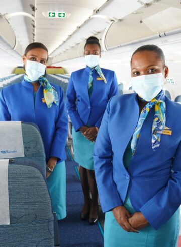 a group of women wearing blue uniforms and face masks