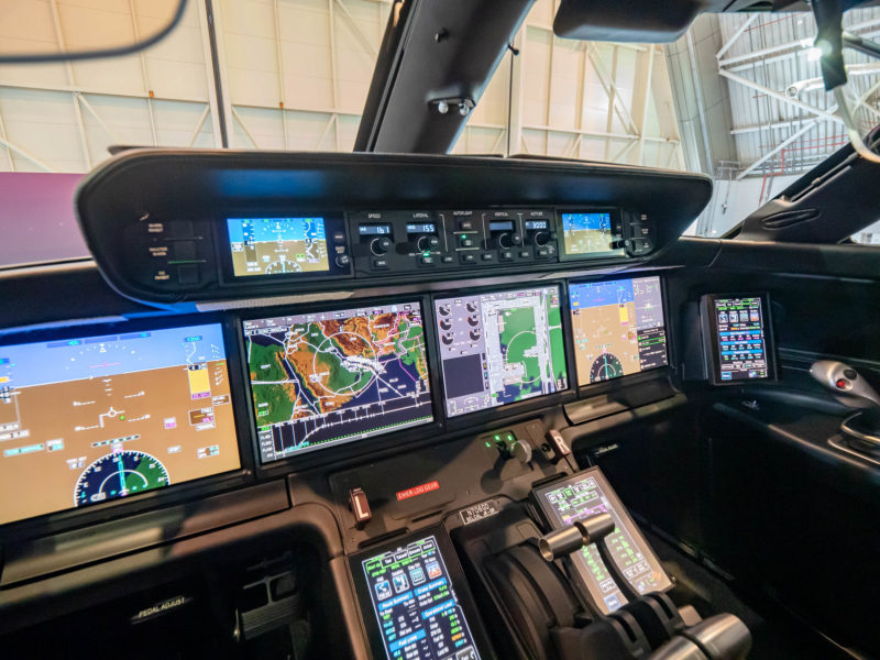 a cockpit with multiple screens and a map