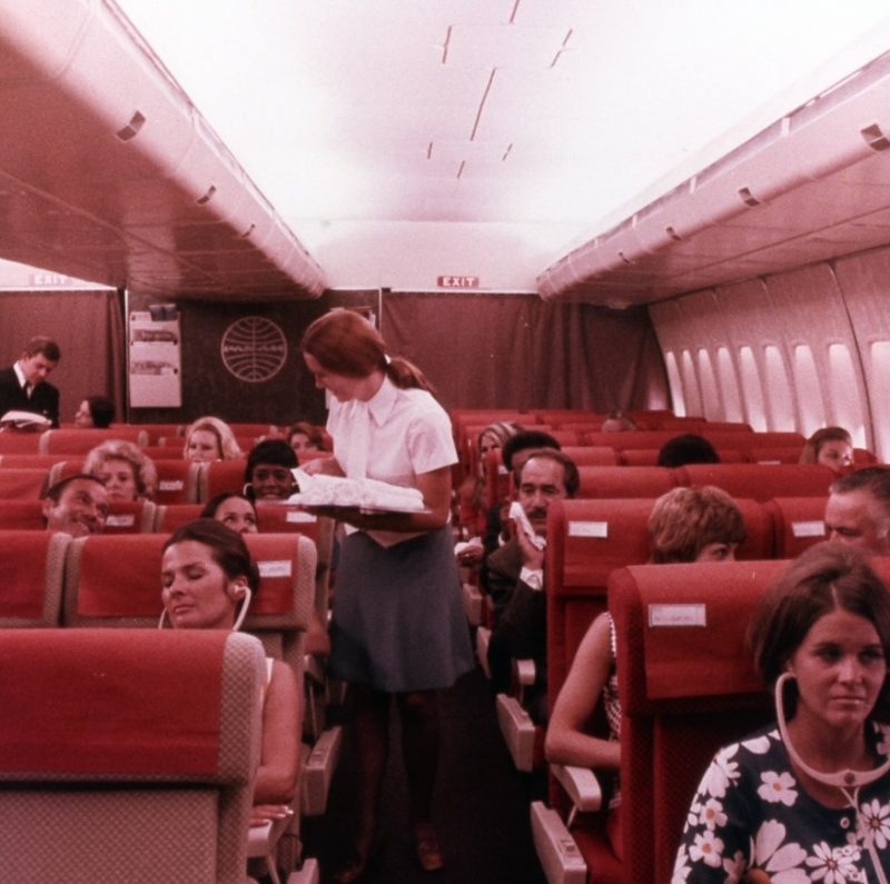 a woman standing in an airplane