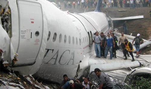 a group of people standing on the side of an airplane