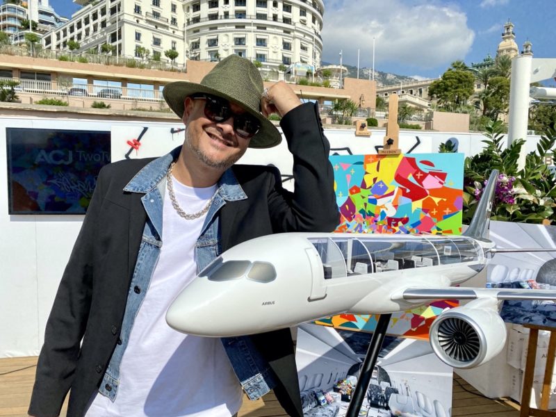 a man posing with a model airplane