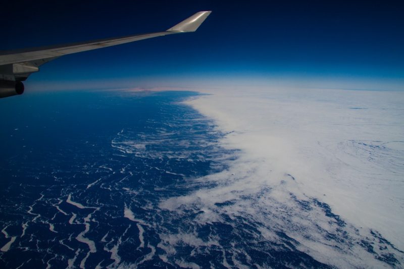 an airplane wing over the earth