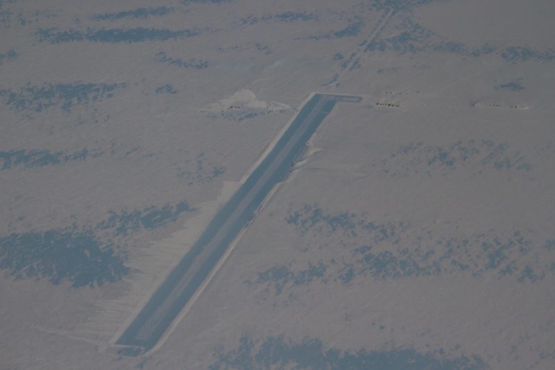 an aerial view of a long rectangular road in the snow