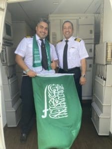 two men in uniform holding a flag