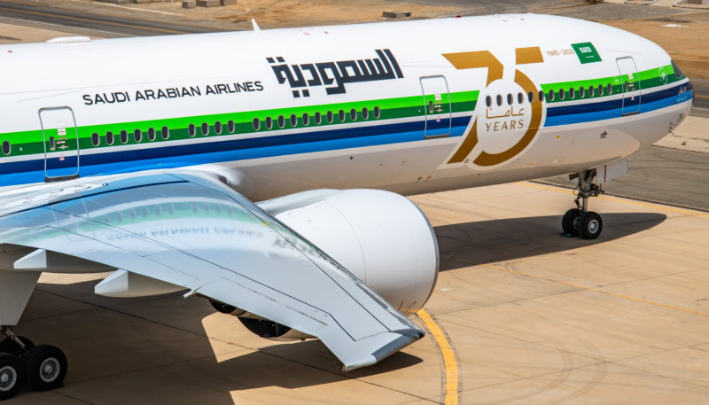 a white airplane with blue and green stripes