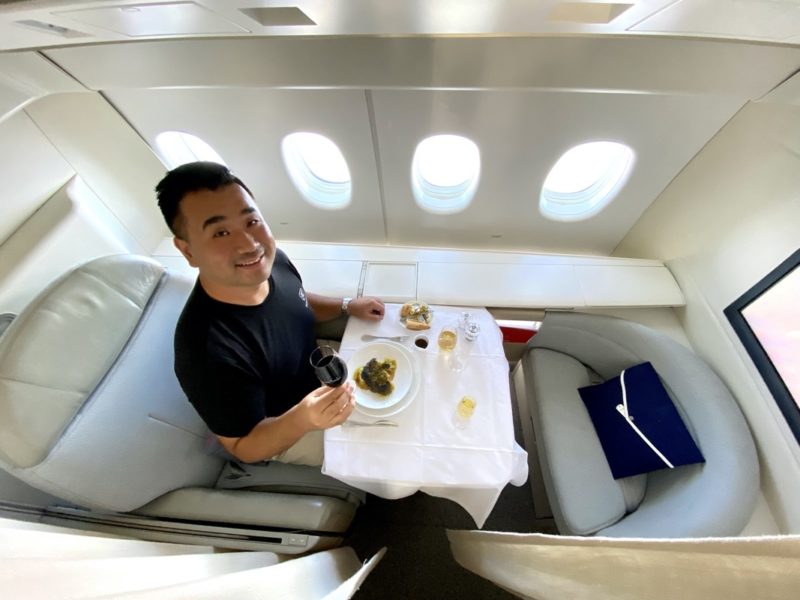 a man sitting at a table in an airplane